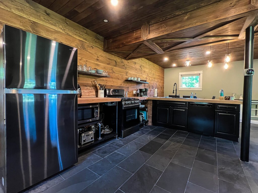 Rustic farmhouse kitchen with island and stainless appliances at The Wayback Cleveland vacation rental near Chagrin Falls