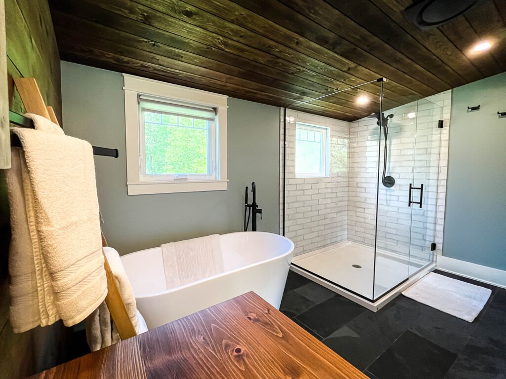 Spa bathroom with soaking tub and tile shower at The Wayback Cleveland vacation rental