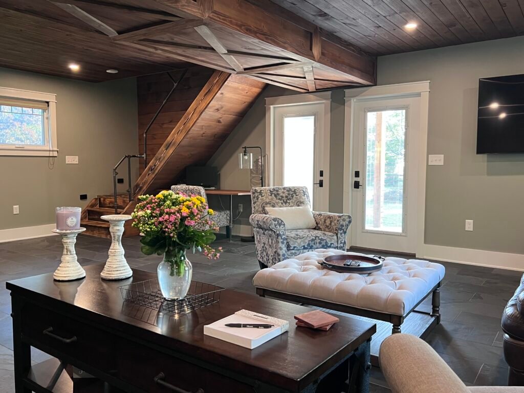 Living room interior at The Wayback Cleveland vacation rental near Chagrin Falls with vaulted wood ceiling and slate floors