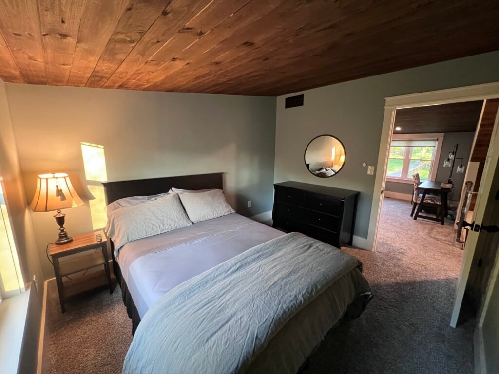 Upstairs bedroom with TV, closet and dresser at The Wayback Cleveland vacation rental near Chagrin Falls