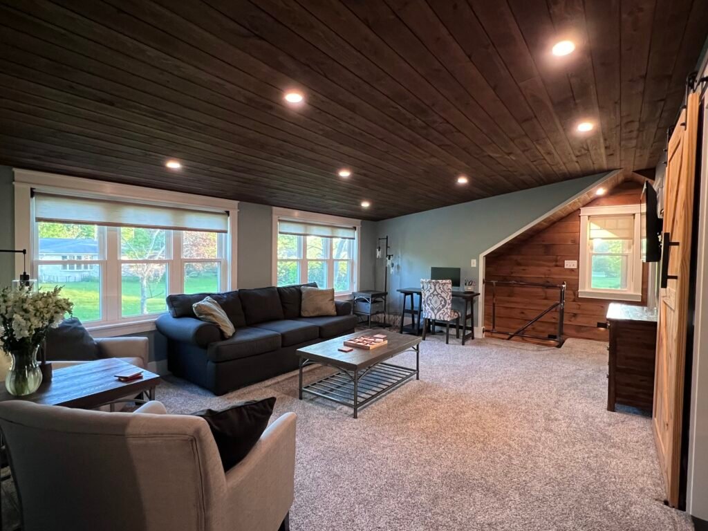Open living room with wood ceiling at The Wayback Cleveland vacation rental near Chagrin Falls