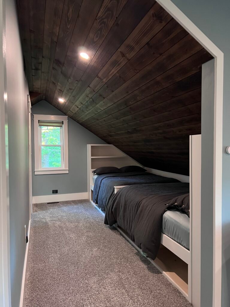 Built-in daybeds under vaulted wood ceiling at The Wayback vacation rental near Cleveland