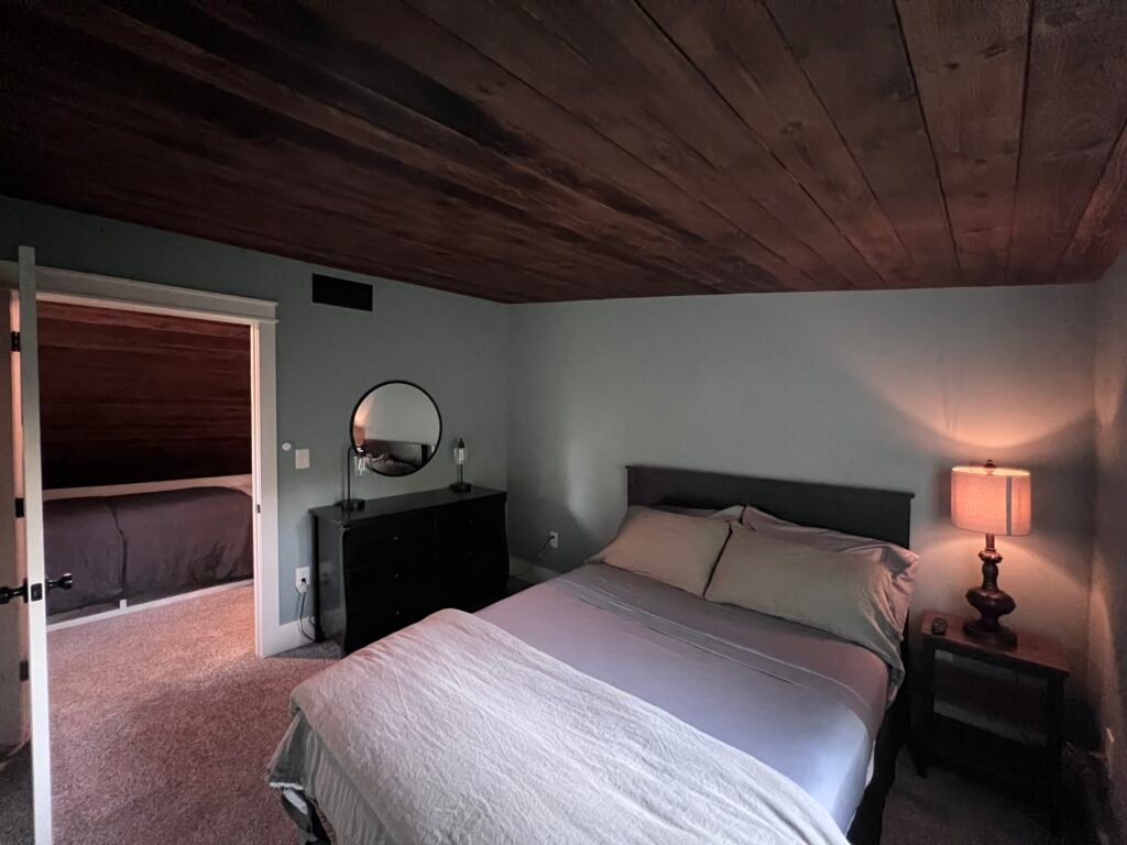 Guest bedroom with wood ceiling at The Wayback Cleveland vacation rental near Chagrin Falls