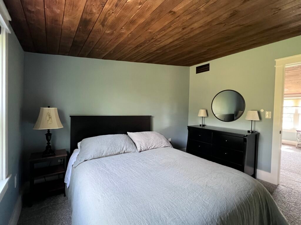Bedroom with wood ceiling at The Wayback Cleveland vacation rental near Chagrin Falls