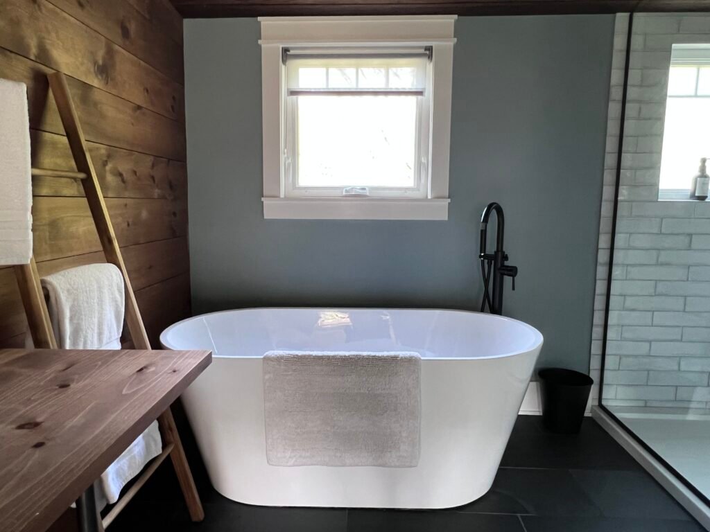 Freestanding soaking tub in spa bathroom at The Wayback Cleveland vacation rental near Chagrin Falls
