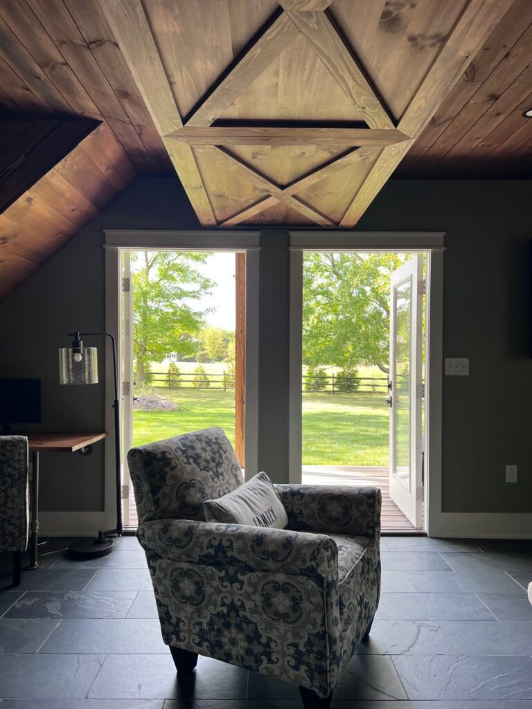 Living room doors opening to wooded yard at The Wayback Cleveland vacation rental
